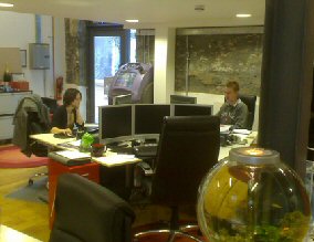 View of the Existem offices. Foreground: famous goldfish bowl. Background: Chris and Louisa